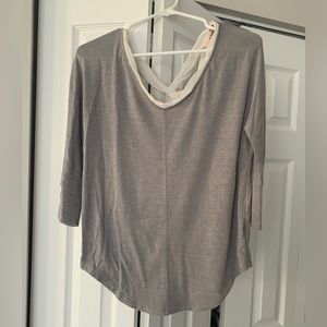 Adorable gray 3/4 shirt with a white criss-cross back detailing